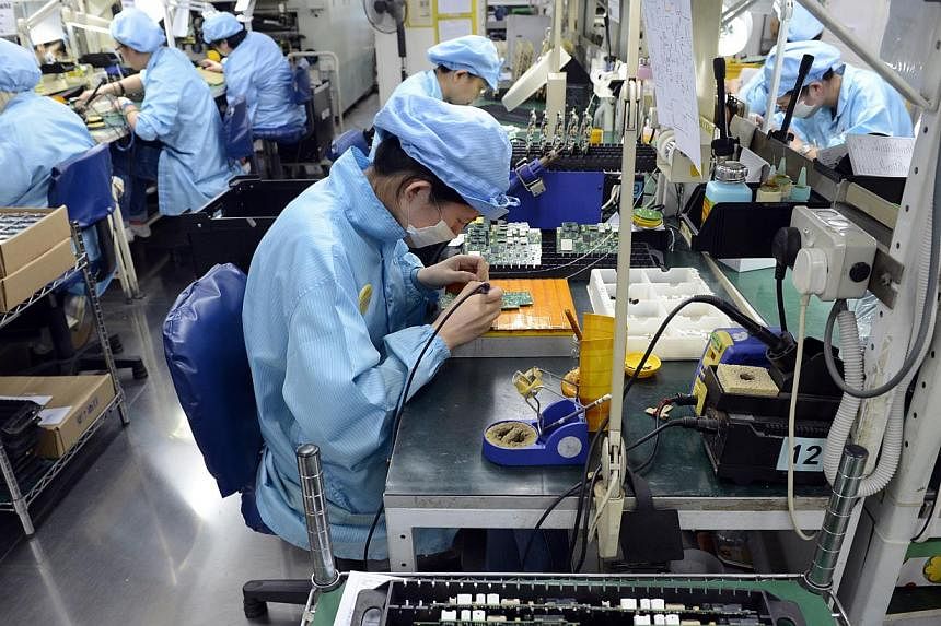 Workers at Add-Plus, an electronics manufacturing company that makes printed circuit boards. -- PHOTO: ST FILE