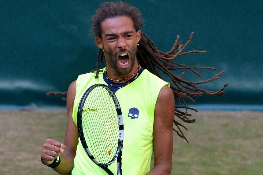 German Dustin Brown celebrates a point during his second round tie match against Rafael Nadal of Spain at the ATP Gerry Weber Open tennis tournament in Halle, western Germany on June 12, 2014. -- PHOTO: AFP