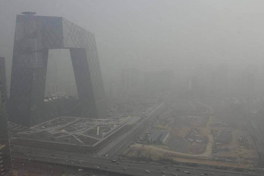 The China Central Television (CCTV) building is seen next to a construction site in heavy haze in Beijing's central business district on Jan 14, 2013.&nbsp;More than a quarter of all companies covered by Beijing's municipal carbon laws ignored a key 