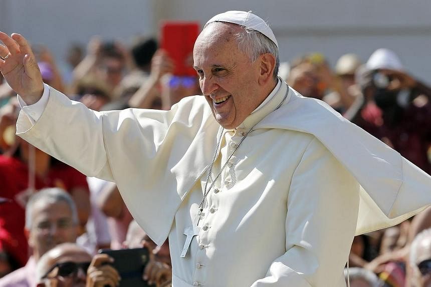 Pope Francis waves as he arrives to lead his weekly general audience at St. Peter's Square at the Vatican on June 11, 2014.&nbsp;Pope Francis said in an interview on Friday, June 13, 2014, that he will ask God's advice when the time comes to consider