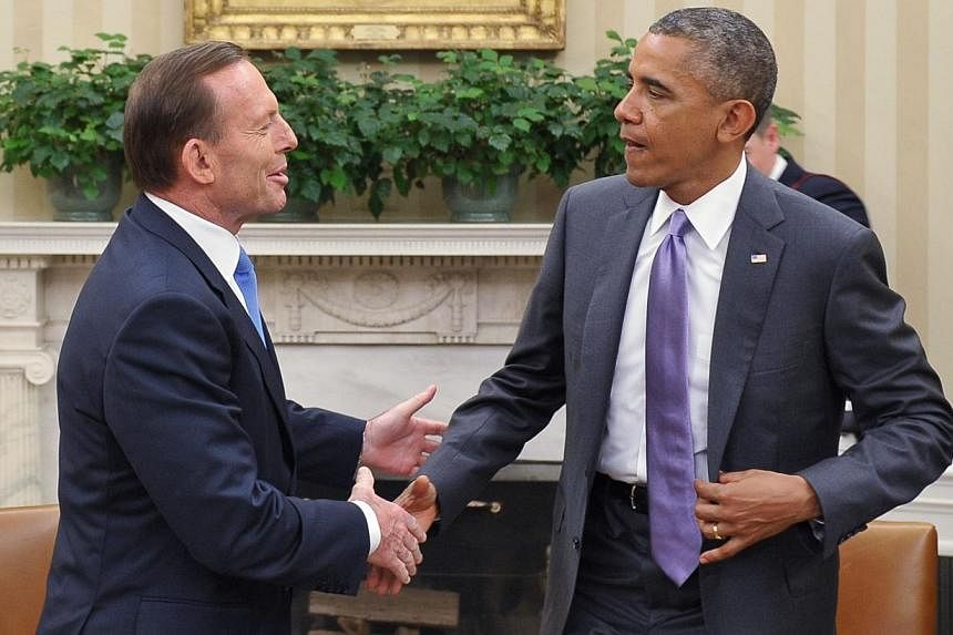 US President Barack Obama and Australian Prime Minister Tony Abbott shake hands following a bilateral meeting in the Oval Office of the White House in Washington, DC&nbsp;on June 12, 2014. -- PHOTO: AFP