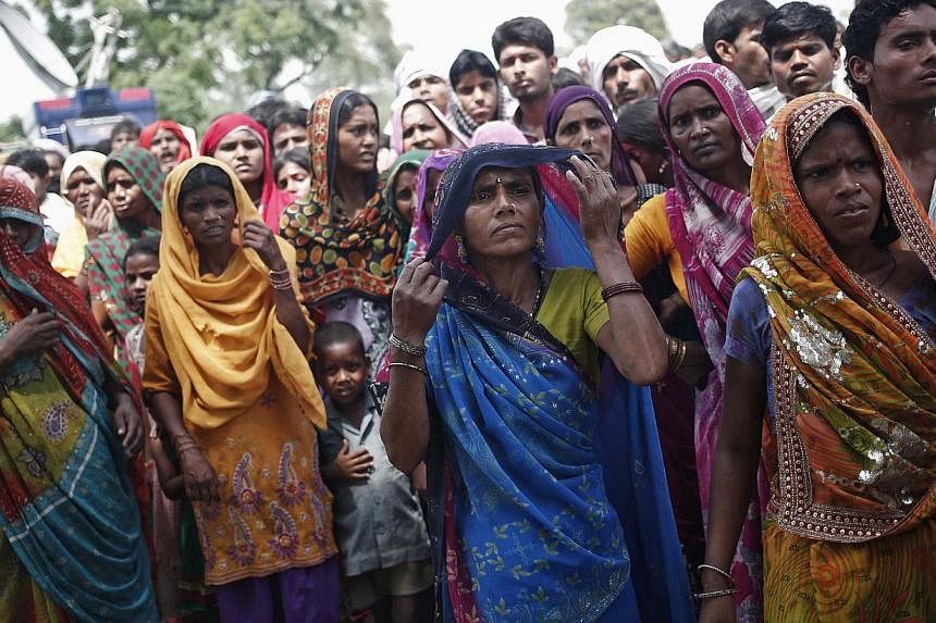 Onlookers gathering on May 31 at the site where two teenage girls, who were answering nature's call, were raped and killed at Budaun district in Uttar Pradesh. Sanitation is a tough challenge as India's population keeps outgrowing the pace of toilet 
