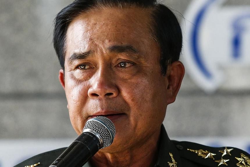 Thai Army chief General Prayuth Chan-ocha speaks during a news conference after the army declared martial law nationwide to restore order, in Bangkok on May 20, 2014. Thailand may have an interim government by August, he said. --PHOTO: REUTERS