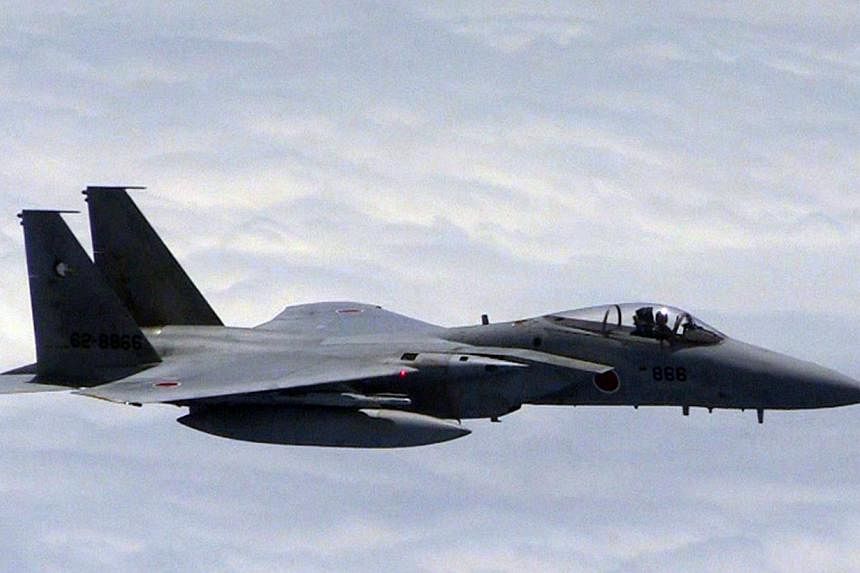 This photo taken on June 11, 2014, released by China's Ministry of National Defence, shows a Japanese F-15 jet approaching a Chinese plane (out of frame) in a spot where the two countries' air defence zones overlap. Japan summoned the Chinese ambassa