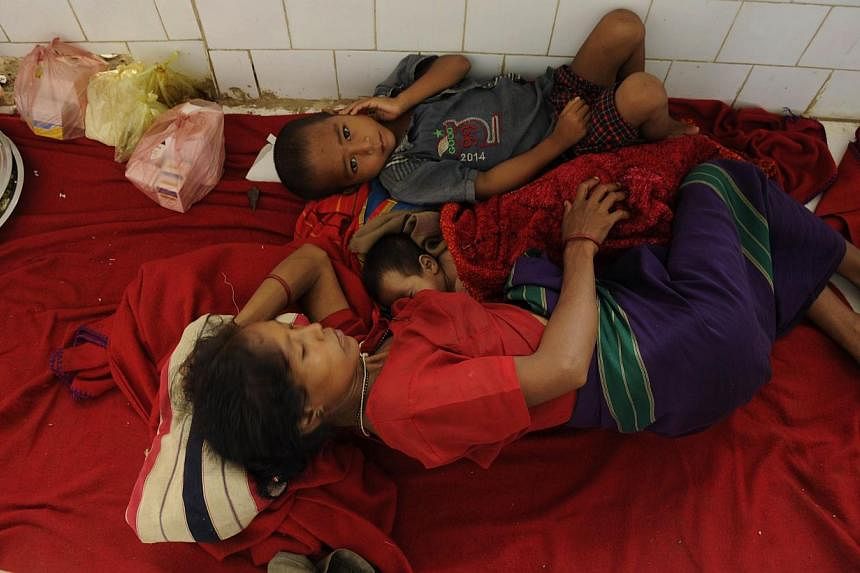 Indian residents infected with malaria lie on the floor of a primary health centre in Gandacharra, some 170 kms north of Agartala, the capital of north-eastern state of Tripura on June 13, 2014.&nbsp;At least 20 people have died from malaria in a rem