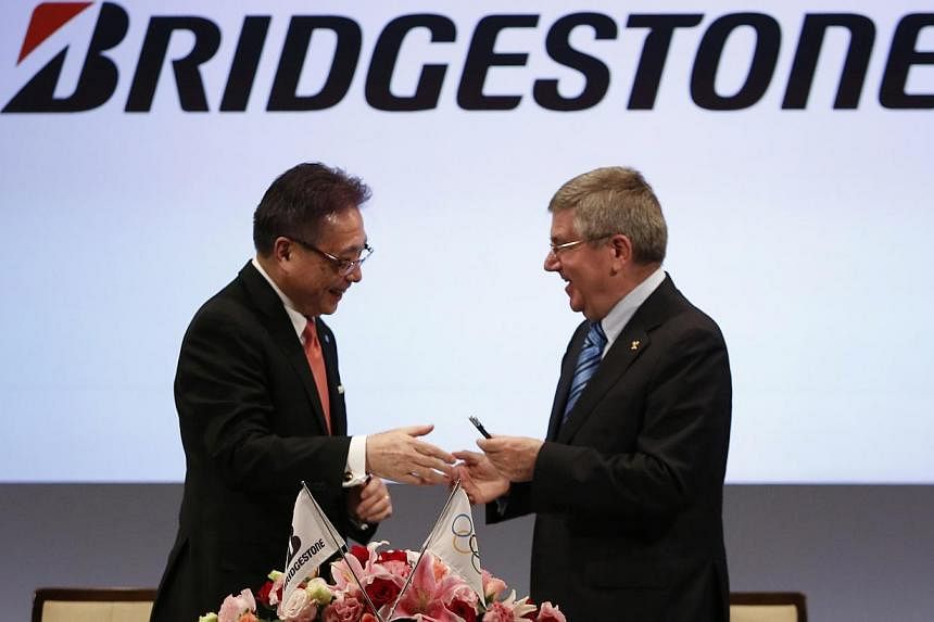International Olympic Committee (IOC) President Thomas Bach (right) shakes hands with Bridgestone CEO Masaaki Tsuya during a signing ceremony making the company an official TOP worldwide Olympic partner through the 2024 Olympic Games, in Tokyo June 1