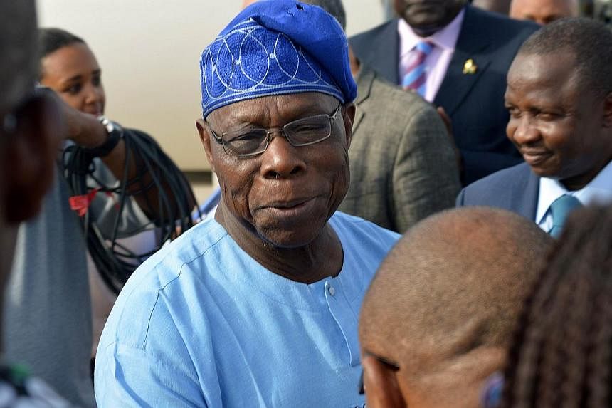 Nigeria's former president Olusegun Obasanjo (centre) told media some of the schoolgirls kidnapped by militant group Boko Haram in April may never return, in the most pessimistic comments yet on their fate from a member of the political elite. -- PHO