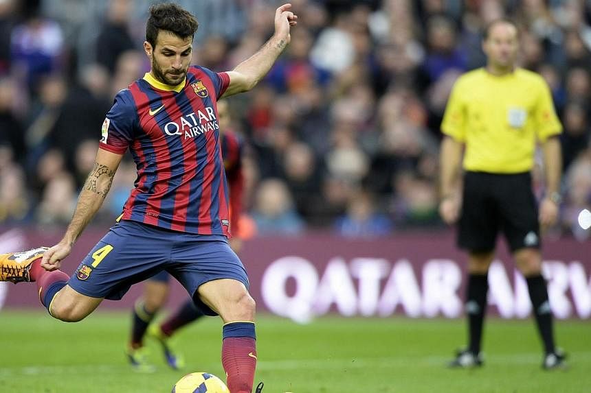Barcelona midfielder Cesc Fabregas scores against CF Granada at the Camp Nou stadium in Barcelona. Arsenal manager Arsene Wenger is surely making a mistake letting Fabregas move to Chelsea. -- PHOTO: AFP