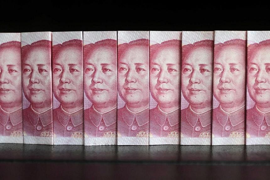 Chinese 100 yuan banknotes. On Friday, the Monetary Authority of Singapore announced more initiatives to promote Singapore as an offshore yuan hub. -- PHOTO: REUTERS