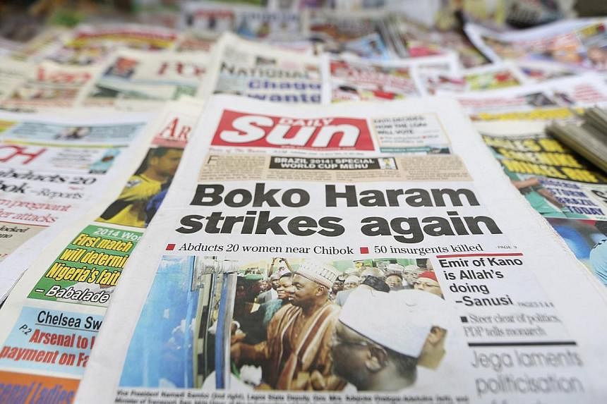 A newspaper with its frontpage headline on an abduction of women from a village in northeast Nigeria, is displayed at a vendor's stand along a road in Ikoyi district in Lagos on June 10, 2014. -- PHOTO: REUTERS
