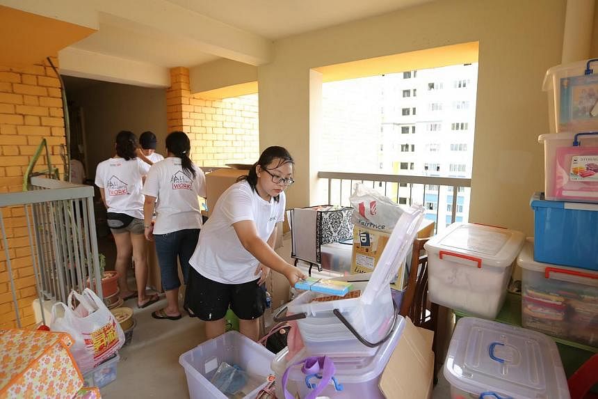 Cass Eng, 13, who benefited from a previous HSBC corporate responsibility event, lending a hand in this year's effort. Here she is sorting out a household's belongings while their flat is being cleared to make way for new furniture.