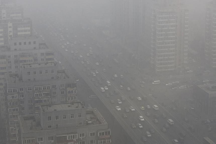Cars drive on the Three Ring Road amid heavy haze in Beijing in this Feb 26, 2014, file photo. -- PHOTO: REUTERS