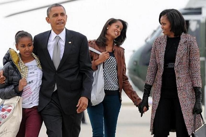 In this November 7, 2012 file photo US President Barack Obama, First Lady Michelle Obama and their daughters Malia and Sasha(left) borad Air Force One at Chicago O'Hare International Airport in Chicago.&nbsp;Father's Day is the day we use to speciall