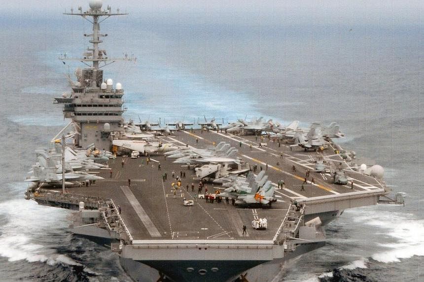 The United States Navy on Sunday welcomed four members of China's military aboard the USS George Washington, one of its aircraft carriers - and said it hoped to receive a return invite someday. -- PHOTO: US NAVY