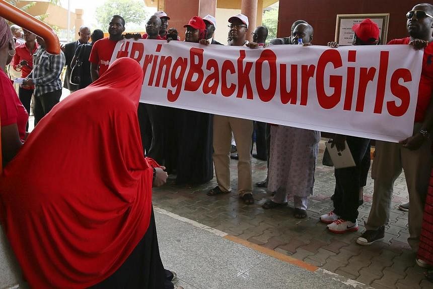 Members of the #BringBackOurGirls campaign group wait along a corridor of the Federal High Court, to challenge the Nigerian police's ban on their daily protests, in Mataima, Abuja on June 3, 2014.&nbsp;Supporters of the more than 200 schoolgirls abdu