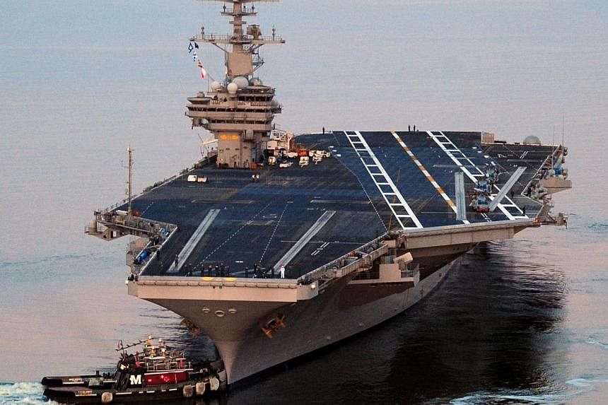 This US Navy photo shows the Nimitz-class aircraft carrier USS George H.W. Bush as it departs Naval Station Norfolk for its maiden deployment May 11, 2011.&nbsp;US Defence Secretary Chuck Hagel ordered an aircraft carrier moved into the Gulf on Satur
