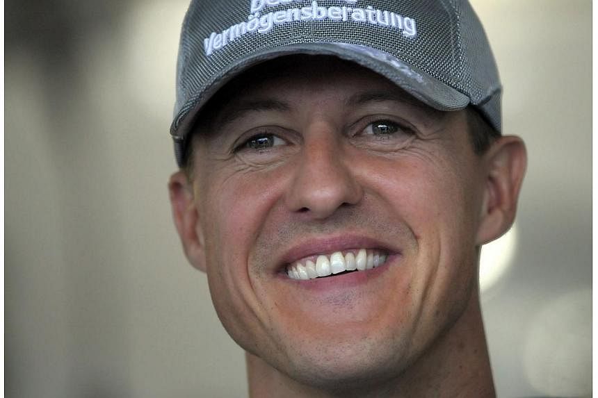 A photo taken on October 9, 2010 shows Mercedes driver Michael Schumacher of Germany smiling in his pits prior to the qualifying session of Formula One's Japanese Grand Prix at the Suzuka circuit in western Japan.&nbsp;Formula One ex-champion Michael