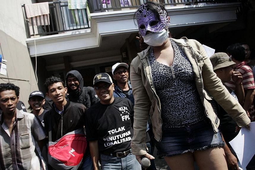 An Indonesian sex worker participates in a protest in Surabaya city's red light district popularly known as Dolly. -- PHOTO: AFP