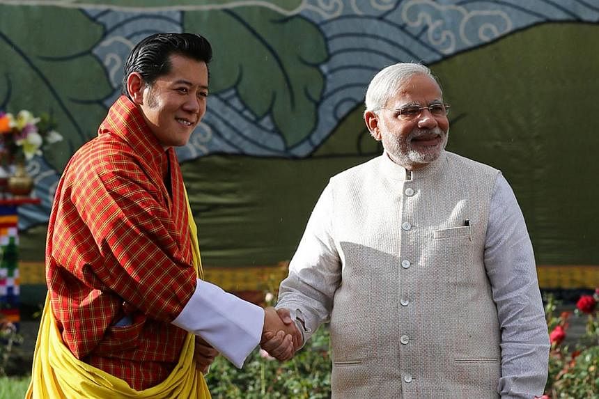 In this handout photograph released by the Royal Office of Media Bhutan, Indian Prime Minister Narendra Modi (right) shakes hands with Bhutanese King Jigme Khesar Namgyel Wangchuck in Thimphu on June 15, 2014. India's Narendra Modi received a grand w