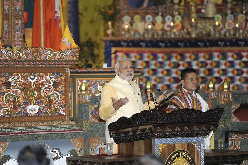 India's Prime Minister Narendra Modi (centre) addresses the joint session of the Parliament at Thimphu in Bhutan on June 16, 2014.&nbsp;India's Narendra Modi on Monday pledged stronger energy ties with tiny neighbour Bhutan as he wrapped up his first