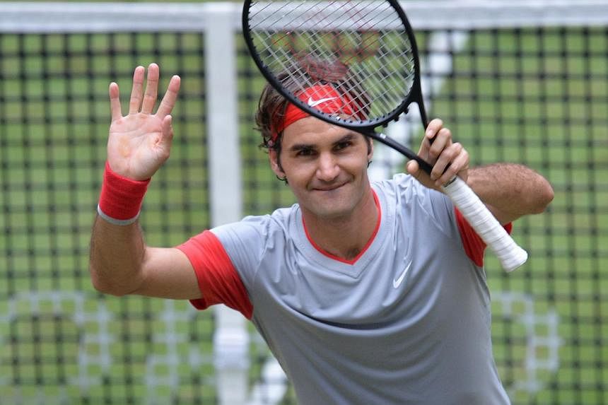 Swiss tennis player Roger Federer celebrates winning his final match against Alejandro Falla from Columbia at the ATP Gerry Weber Open tennis tournament in Halle, western Germany on June 15, 2014. -- PHOTO: AFP