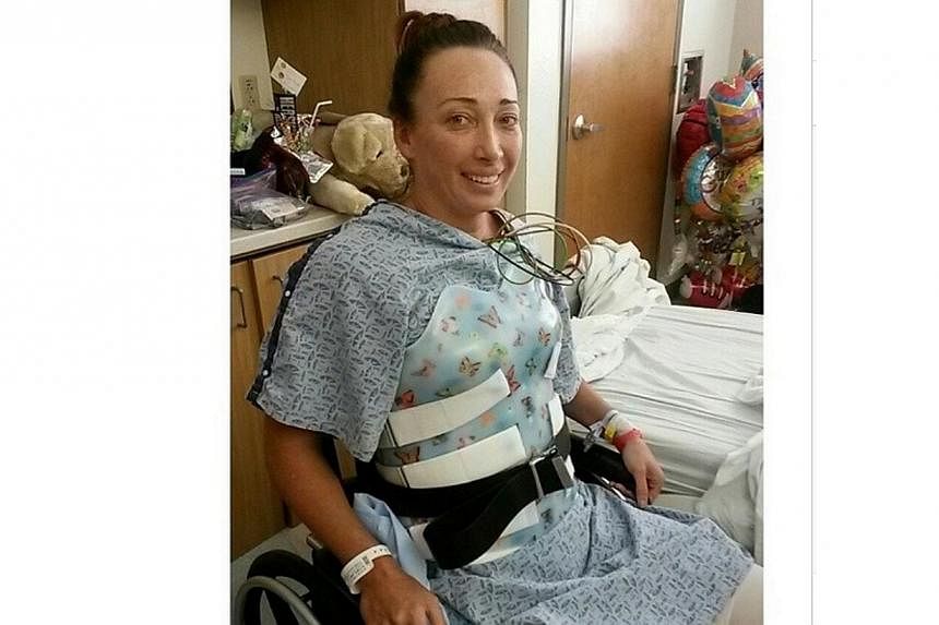 Six-time Olympic swimming champion Amy Van Dyken Rouen, seen here sitting in a wheel chair in a picture taken one day ago. She was moved out of intensive care on Sunday, nine days after her spinal cord was severed in an all-terrain vehicle accident. 