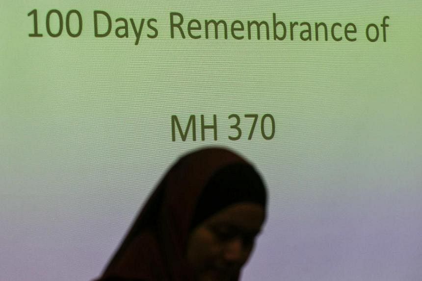 A family member of a Malaysian passenger on board the missing Malaysia Airlines Flight 370 stands near the during 100 Days Remembrance of MH370 in Kuala Lumpur June 15, 2014. -- PHOTO: REUTERS