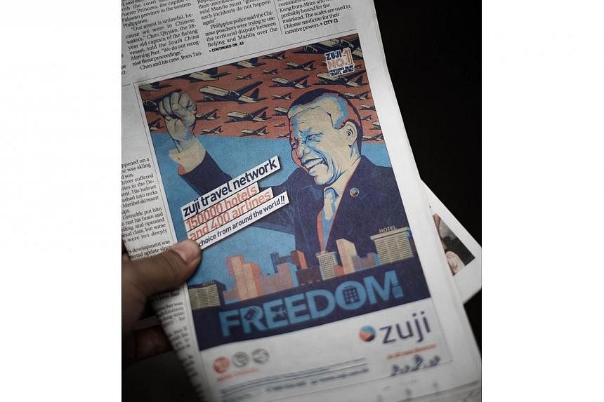 This photo illustration shows a front-page newspaper advertisement featuring an image of Nelson Mandela in Hong Kong on June 17, 2014. -- PHOTO: AFP/PHILIPPE LOPEZ
