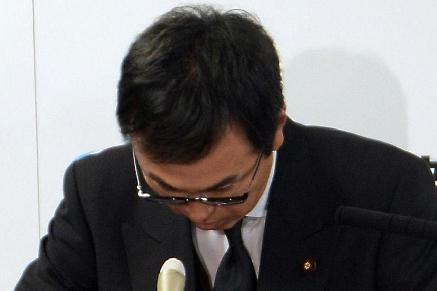 Japanese Environment Minister Nobuteru Ishihara bows his head as he apologies after appearing to suggest people in nuclear disaster-hit Fukushima could be persuaded to put up with contaminated waste if the government threw cash at them, at his office