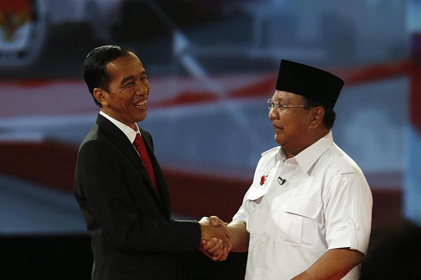 Indonesian presidential candidates Joko Widodo (left) and Prabowo Subianto after Sunday's presidential debate. The latter came out with all guns blazing on Sunday in a complete turnaround.