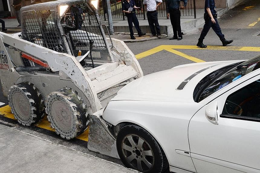 On Sunday, a man took a skid loader from a worksite and went on a drunken rampage, damaging a bus stop and four taxis. -- PHOTO: SHIN MIN DAILY NEWS