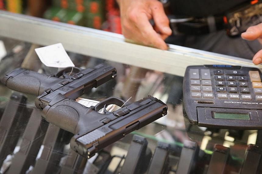 A customer shops for a handgun at Freddie Bear Sports&nbsp;in Tinley Park, Illinois&nbsp;on June 16, 2014. -- PHOTO: AFP