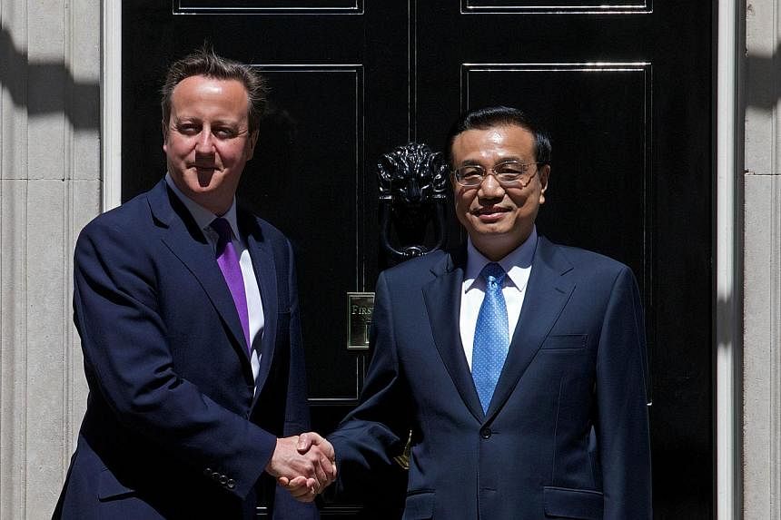 British Prime Minister David Cameron (left) shaking hands with Chinese Premier Li Keqiang outside No. 10 Downing Street ahead of a meeting in London on June 17, 2014. Mr Li met Mr Cameron for talks at his Downing Street office, aimed at boosting econ