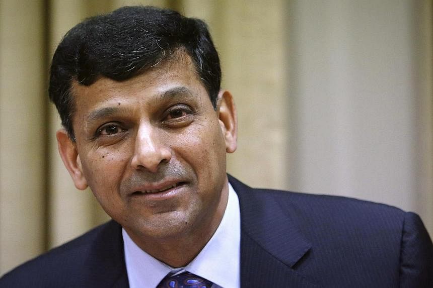 Reserve Bank of India (RBI) Governor Raghuram Rajan smiling after arriving for a quarterly interest rate review briefing at the RBI headquarters in Mumbai in this October 29, 2013 file photo. India is ready to deal with any external shock arising fro