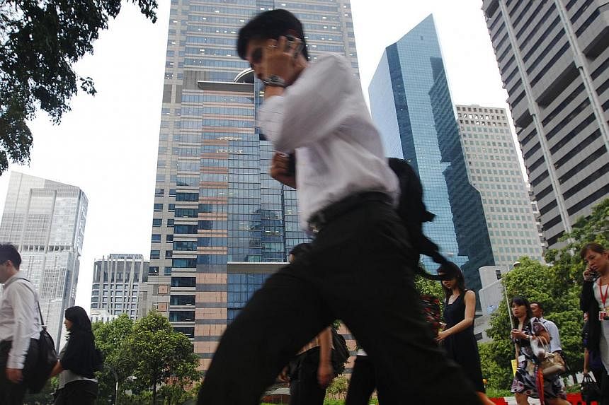 A survey of 5,670 Singapore workers found that nearly half - 46 per cent - do not like their jobs, while three-quarters see their job as nothing more than a way to put food on the table. -- PHOTO: ST FILE