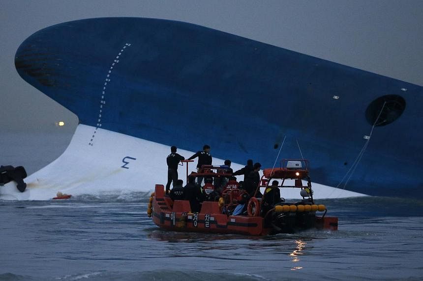 Maritime police search for missing passengers in front of the South Korean ferry "Sewol" which sank at the sea off Jindo in this April 16, 2014, file photo.&nbsp;The surviving crew of the Sewol argued on Tuesday that once the coast guard reached the 