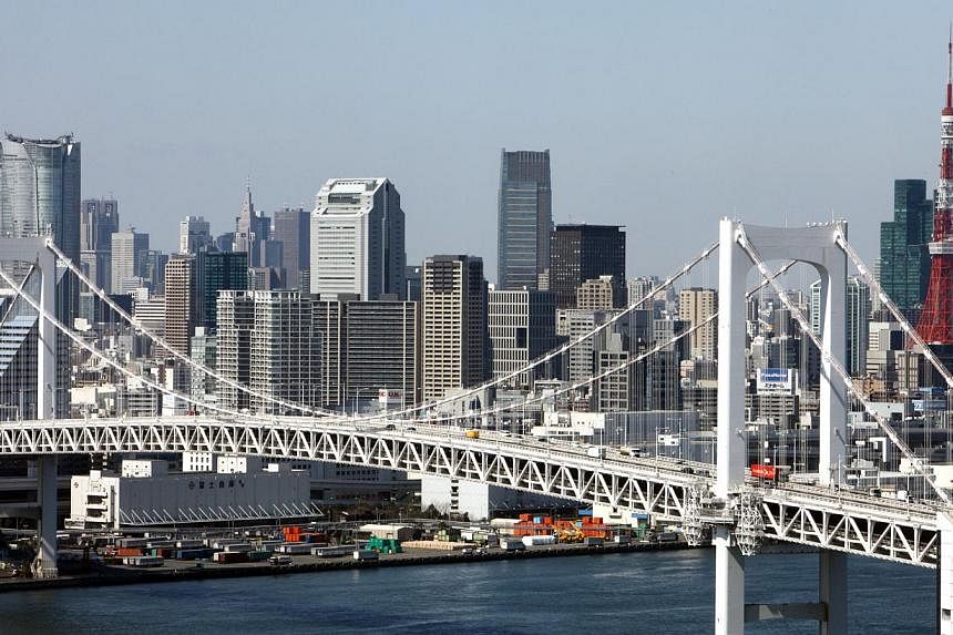 Commercial buildings stand behind the Rainbow Bridge in Tokyo, Japan, on March 11, 2010. Japan said on June 17, 2014, that it would relax visa rules for tourists from Indonesia, the Philippines and Vietnam in a bid to double the number of foreign vis