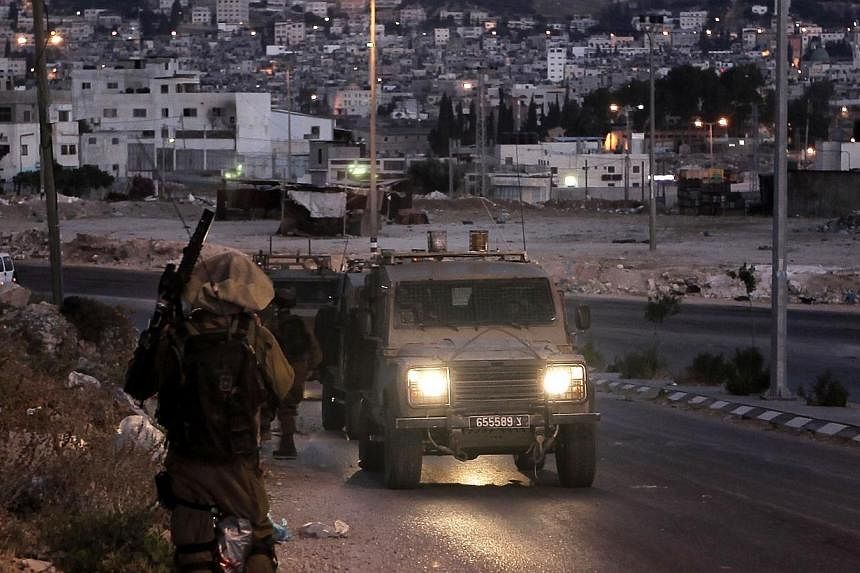 &nbsp;Israeli soldiers take part in a search operation for three Israeli teenagers believed kidnapped by Palestinian militants, early on June 18, 2014 in the West Bank town of Nablus.&nbsp;Israeli troops arrested 65 Palestinians overnight, most of wh