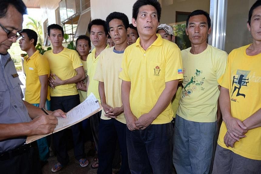 Vietnamese fishermen (right), who were arrested on March 21 with a boatload of sharks off the western island of Palawan, waiting for their court hearing to start in Puerto Princesa, Palawan island on June 4, 2014.&nbsp;A Philippine court on Wednesday