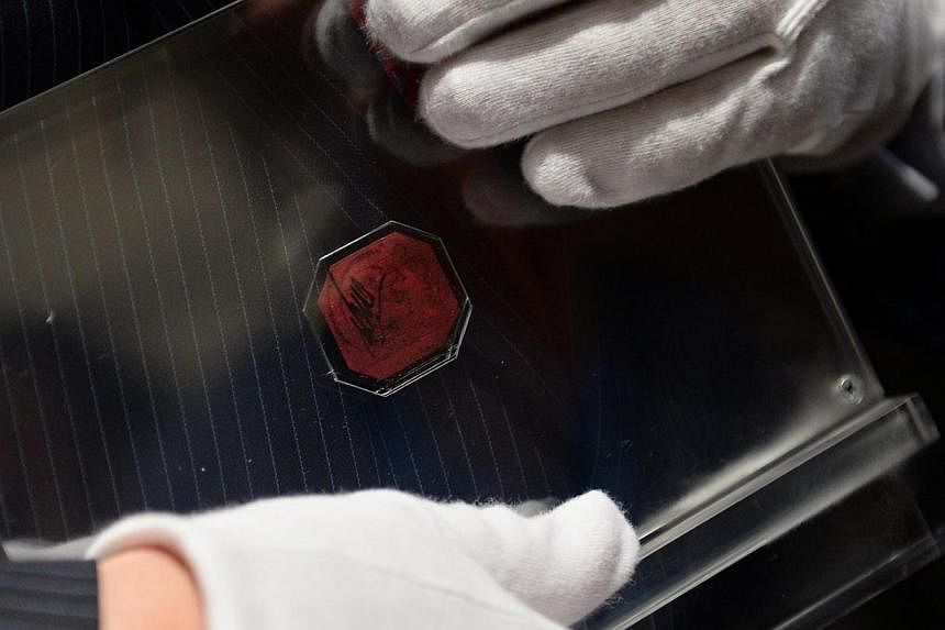Mr David Redden, Sotheby's Vice-Chairman, holds the British Guiana One-Cent Magenta after it sold for US$9.5 million at Sotheby's June 17, 2014 in New York. Described as the most famous stamp in the world, no stamp is rarer than the sole-surviving ex