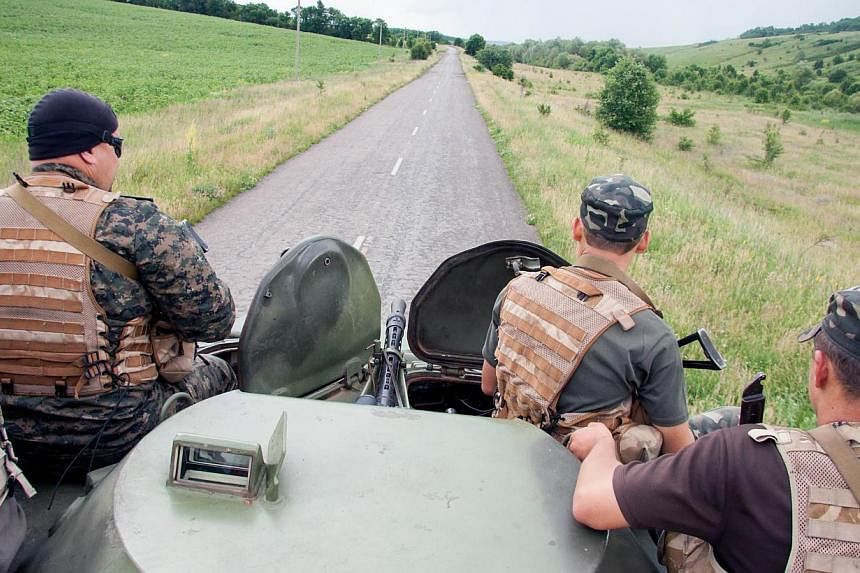 Ukrainian troops patrol an area near the border of Ukraine with Russia outside Kharkiv on June 16, 2014.&nbsp;Ukraine's new President Petro Poroshenko said on Wednesday that he will soon order a unilateral ceasefire in the separatist east as part of 