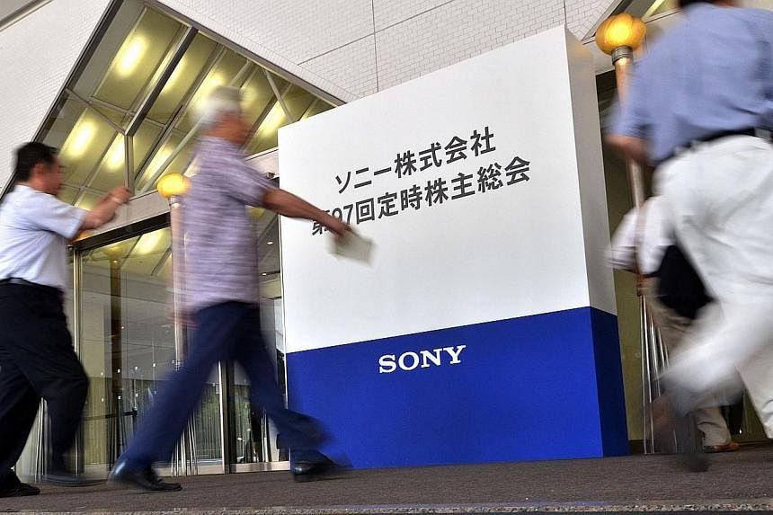 People arrive for a shareholders meeting for Japan's electronics giant Sony in Tokyo on June 19, 2014. &nbsp;Some of Japan's best-known companies, such as Sony, Japan Airlines and fast-food chain Yoshinoya, are seeing attendance plummet at their shar