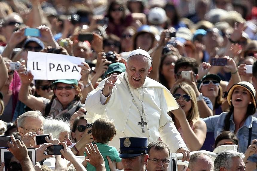 Pope Francis waves as he arrives at his weekly general audience at St. Peter's Square at the Vatican June 18, 2014. -- PHOTO: REUTERS