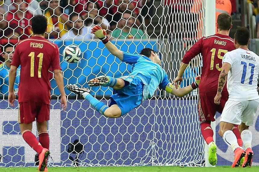 Spain's goalkeeper and captain Iker Casillas fails to save a goal during a Group B football match between Spain and Chile in the Maracana Stadium in Rio de Janeiro during the 2014 FIFA World Cup on June 18, 2014. -- PHOTO: REUTERS