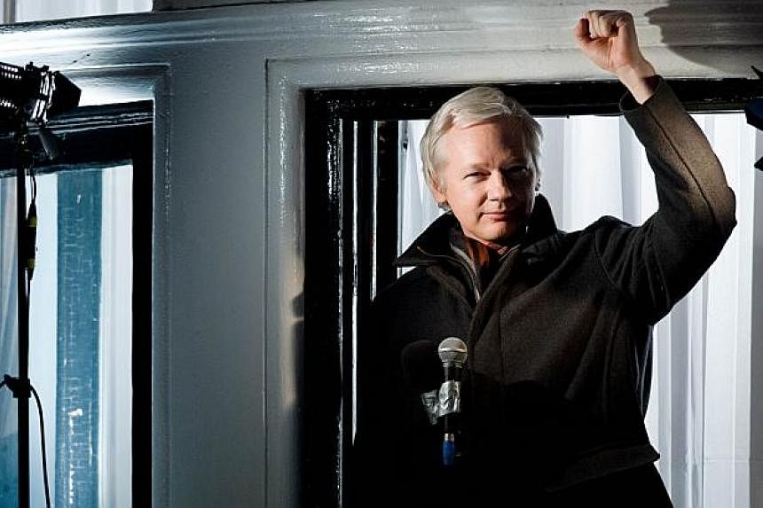 In this file picture taken on Dec 20, 2012 Wikileaks founder Julian Assange addresses members of the media and supporters from the window of the Ecuadorian embassy in Knightsbridge, west London. -- PHOTO: AFP