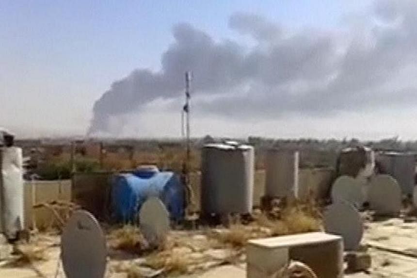A large plume of smoke rises from what is said to be Baiji oil refinery in Baiji, northern Iraq, in this still image taken from an amateur video posted on a social media website June 18, 2014. -- PHOTO: REUTERS