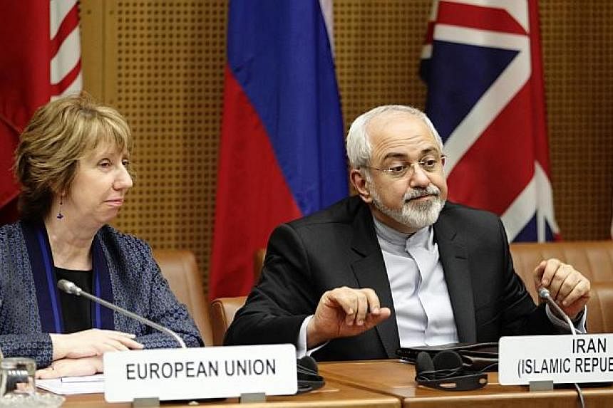 European Union Foreign Policy Chief Catherine Ashton (left) and Iranian Foreign Minister Mohammad Javad Zarif wait for the begin of talks in Vienna June 17, 2014. -- PHOTO: REUTERS