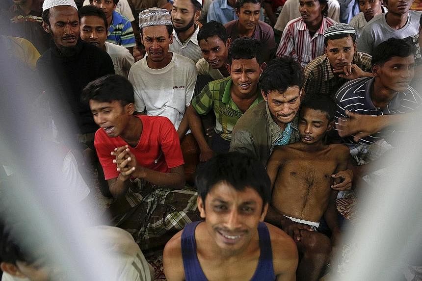 Rohingya people from Myanmar, who were rescued from human traffickers, react from inside a communal cell at Songkhla Immigration Detention Centre (IDC) where they are kept near Thailand's border with Malaysia on Feb 13, 2014.&nbsp;The United States S