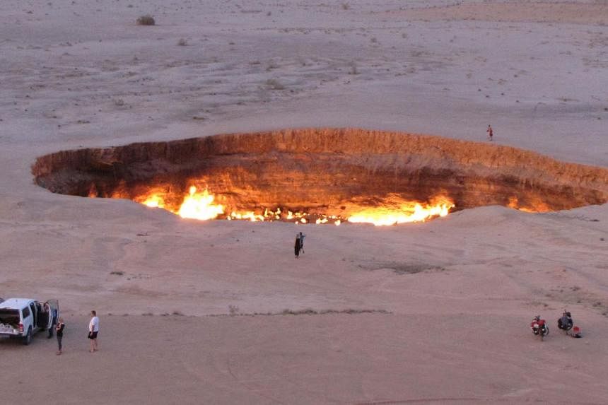 People visiting "The Door to Hell", a huge burning gas crater in the heart of Turkmenistan's Karakum desert on May 3. The fiery pit was the result of a simple miscalculation by Soviet scientists in 1971 after their boring equipment suddenly drilled t