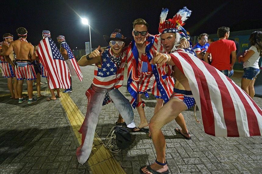 US fans celebrating after their team beat Ghana 2-1 in their first match of the 2014 World Cup outside the Das Dunas Stadium in Brazil's Natal on Monday. Across the world, millions are following the fortunes - or misfortunes - of their teams as one c